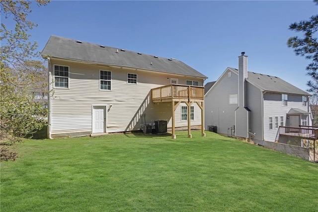 2551 Tolliver Dr, Ellenwood, GA 30294 - rear view of house with central air condition unit, a lawn, and a wooden deck