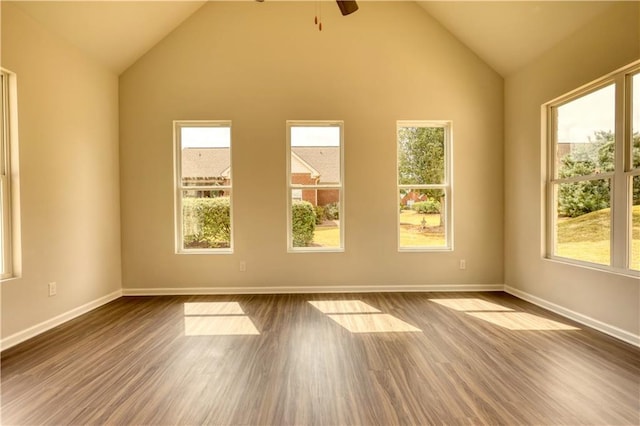 empty room with wood-type flooring, lofted ceiling, and ceiling fan