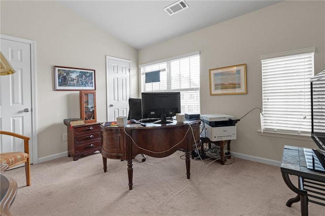 carpeted office space with plenty of natural light, lofted ceiling, and baseboards