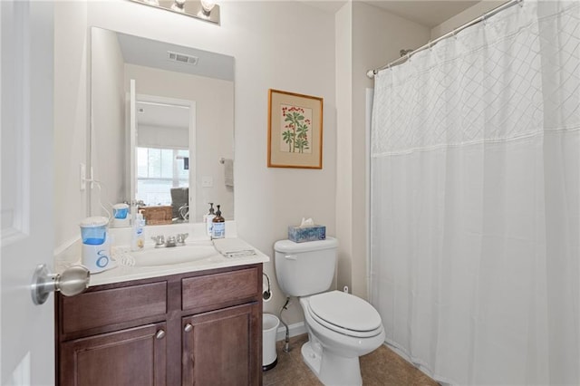 bathroom featuring toilet, walk in shower, vanity, and tile patterned flooring