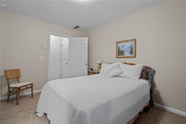 bedroom with light carpet and baseboards