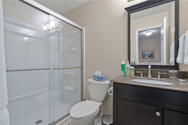 bathroom featuring a shower with door, toilet, a chandelier, and vanity