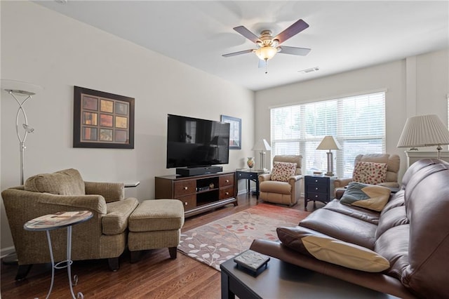 living room with ceiling fan and dark hardwood / wood-style floors