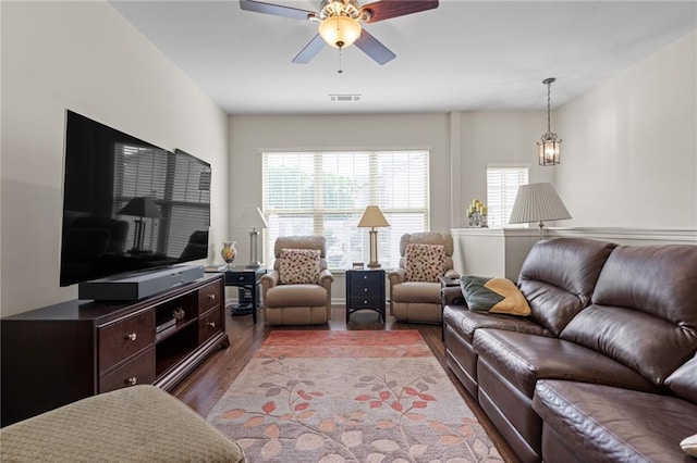 living room featuring wood-type flooring and ceiling fan