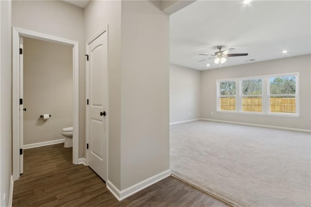 hall featuring dark wood-style floors, recessed lighting, dark carpet, and baseboards