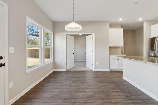 unfurnished dining area featuring recessed lighting, baseboards, and dark wood-style flooring