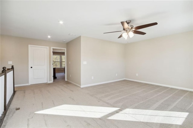 unfurnished room featuring recessed lighting, light colored carpet, baseboards, and ceiling fan