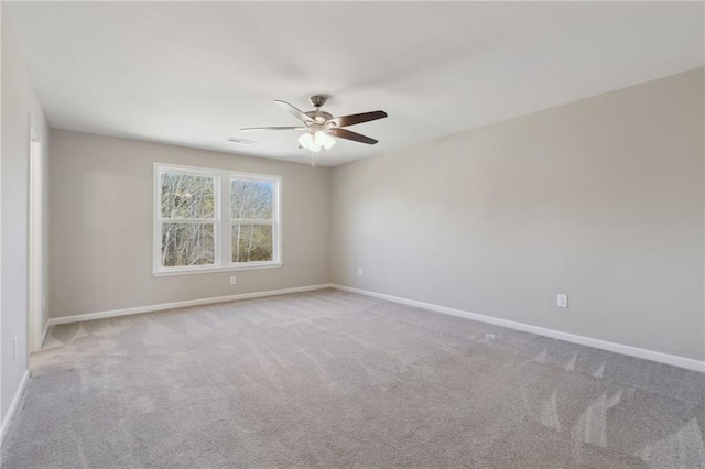 unfurnished room featuring visible vents, baseboards, carpet floors, and ceiling fan