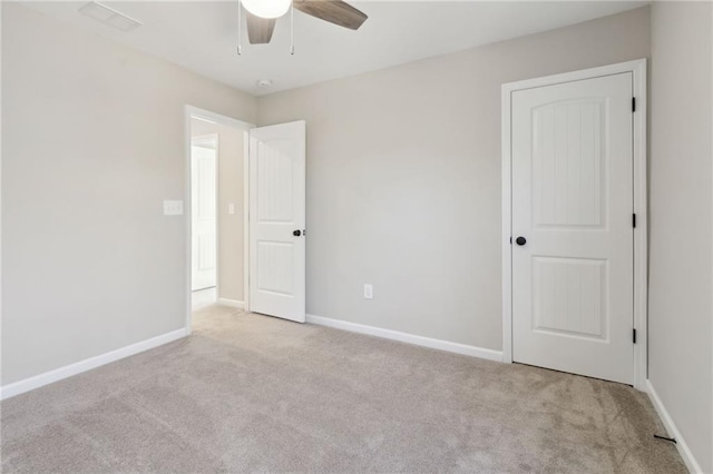 unfurnished bedroom featuring visible vents, baseboards, and carpet