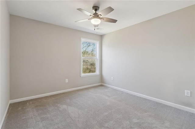 carpeted empty room with visible vents, ceiling fan, and baseboards