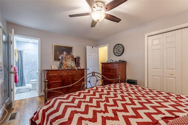 bedroom featuring ceiling fan, wood-type flooring, ensuite bathroom, and a closet