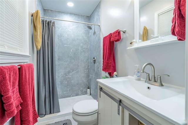 bathroom featuring curtained shower, toilet, and vanity