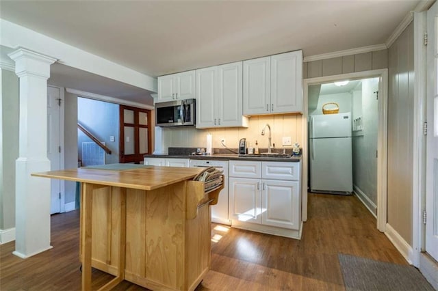 kitchen with a center island, ornate columns, sink, white cabinets, and stainless steel appliances