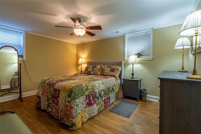 bedroom featuring crown molding, hardwood / wood-style floors, and ceiling fan