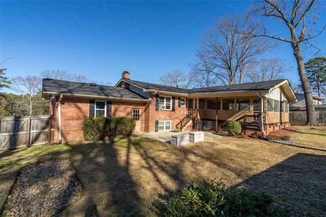 rear view of property with a lawn