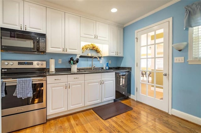 kitchen featuring sink, light wood-type flooring, white cabinetry, and stainless steel appliances