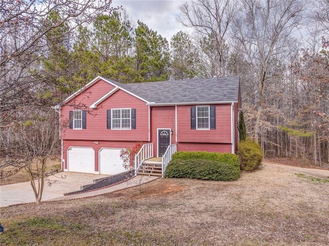 raised ranch featuring driveway and an attached garage