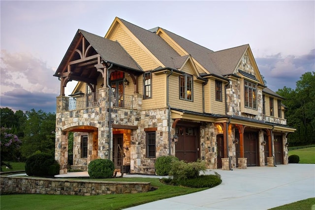 view of front of home with a balcony and a front lawn