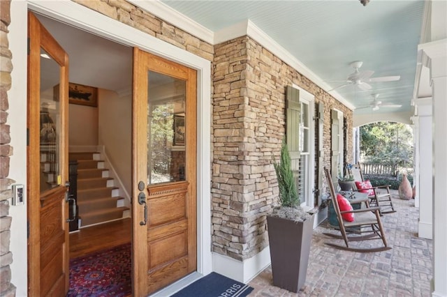 doorway to property featuring ceiling fan