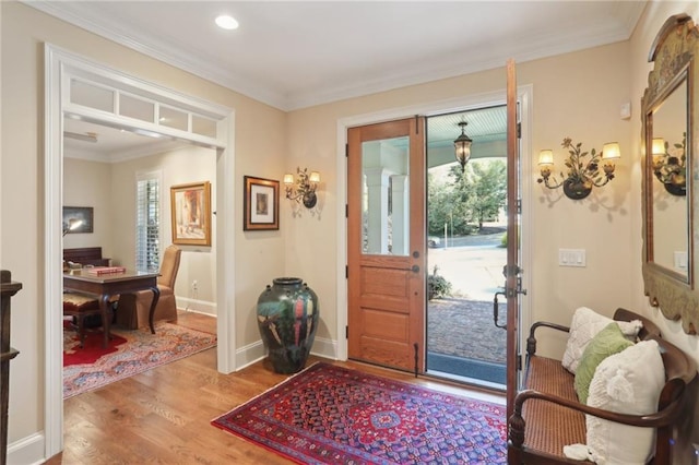 entrance foyer with wood-type flooring and ornamental molding