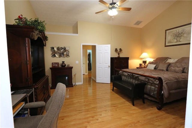 bedroom featuring ceiling fan, lofted ceiling, and light hardwood / wood-style flooring