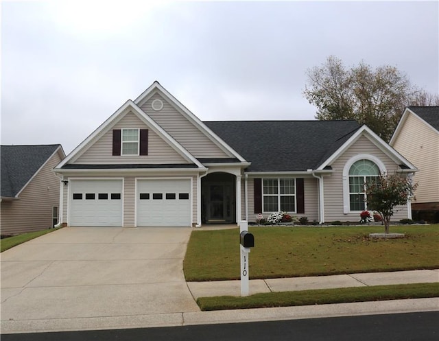 view of front facade with a garage and a front lawn