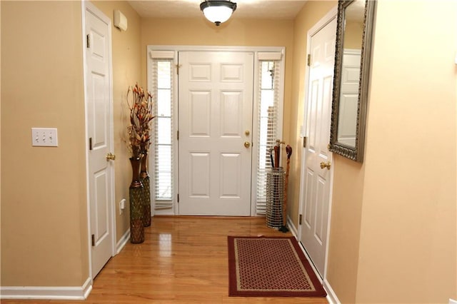 doorway to outside with light hardwood / wood-style floors and plenty of natural light