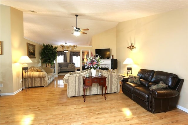 living room featuring ceiling fan, lofted ceiling, and light hardwood / wood-style floors