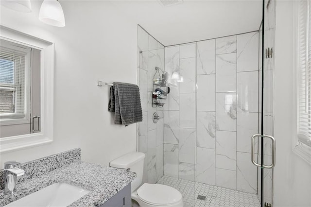 bathroom featuring walk in shower, vanity, and toilet