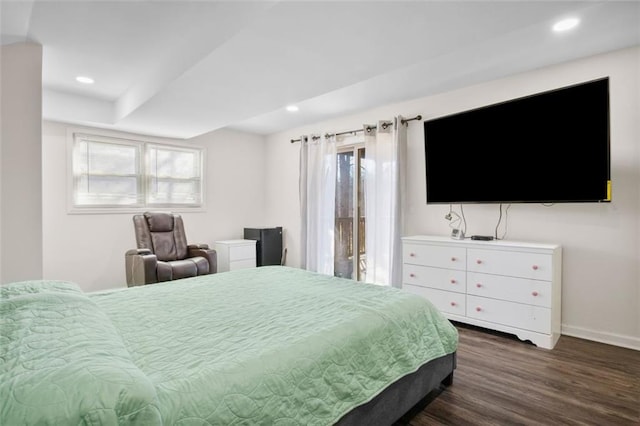 bedroom with dark hardwood / wood-style flooring