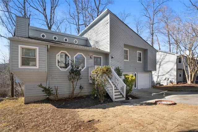 back of house featuring a garage