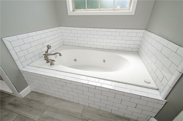 bathroom with a tub with jets