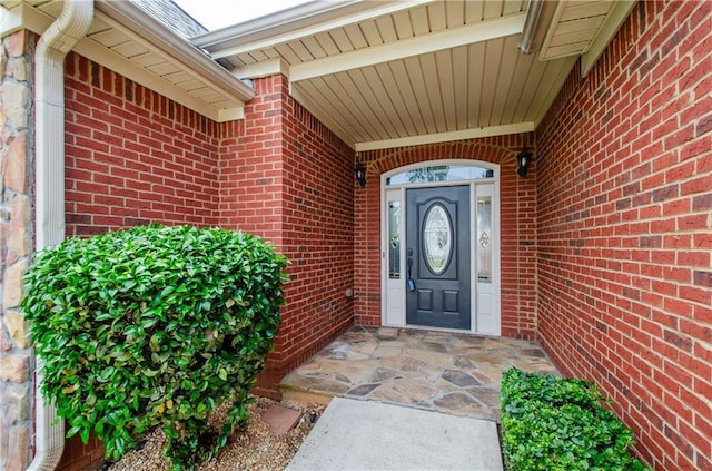 property entrance with brick siding