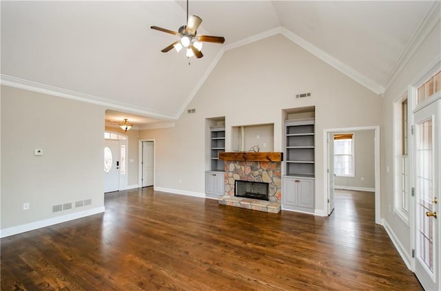 unfurnished living room featuring built in shelves, a ceiling fan, high vaulted ceiling, a stone fireplace, and baseboards