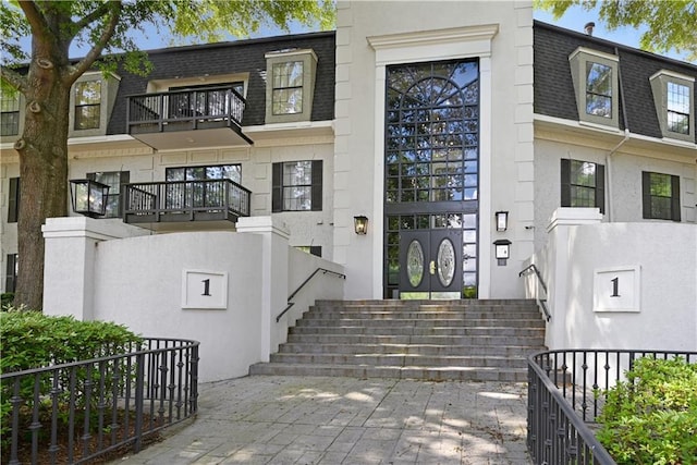 1312 Pine Heights Dr NE, Atlanta, GA 30324 - doorway to property with mansard roof, roof with shingles, and a balcony