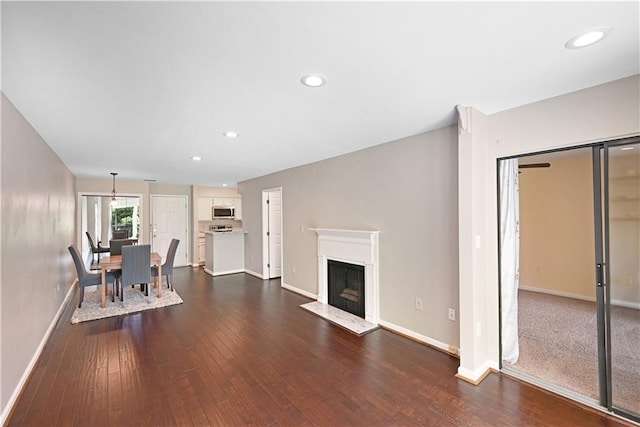 1312 Pine Heights Dr NE, Atlanta, GA 30324 - unfurnished living room featuring baseboards, dark wood-style floors, recessed lighting, and a fireplace