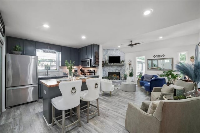 9050 Pine Tree Cir, Gainesville, GA 30506 - kitchen with appliances with stainless steel finishes, open floor plan, healthy amount of natural light, light wood-style floors, and recessed lighting