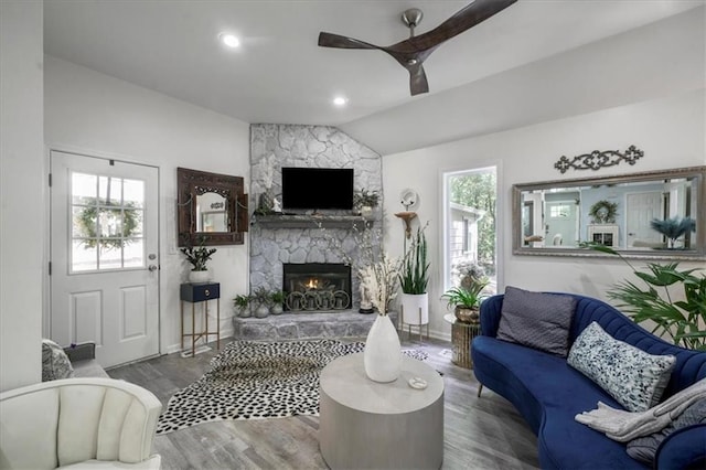 9050 Pine Tree Cir, Gainesville, GA 30506 - living room with a ceiling fan, healthy amount of natural light, a stone fireplace, wood finished floors, and lofted ceiling