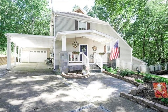 9050 Pine Tree Cir, Gainesville, GA 30506 - american foursquare style home featuring a porch, concrete driveway, an attached garage, and a carport