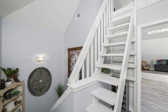 9050 Pine Tree Cir, Gainesville, GA 30506 - stairs with wood finished floors and lofted ceiling