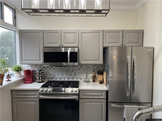 2479 Peachtree Rd NE Unit 105, Atlanta, GA 30305 - kitchen with stainless steel appliances, gray cabinets, light countertops, backsplash, and crown molding