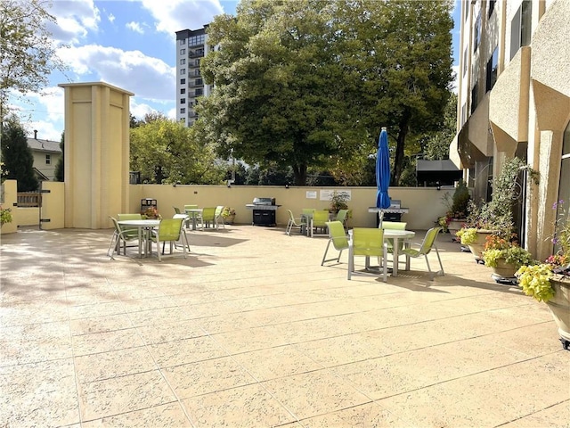 2479 Peachtree Rd NE Unit 105, Atlanta, GA 30305 - view of patio featuring outdoor dining space, fence, and grilling area