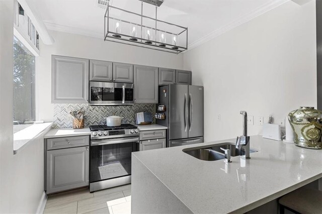 2479 Peachtree Rd NE Unit 105, Atlanta, GA 30305 - kitchen with appliances with stainless steel finishes, gray cabinets, crown molding, a sink, and decorative backsplash