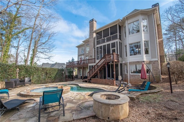 view of swimming pool featuring a patio, stairway, a wooden deck, an outdoor fire pit, and a jacuzzi