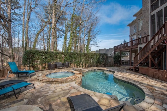 view of pool with stairway, a patio, a wooden deck, and a pool with connected hot tub