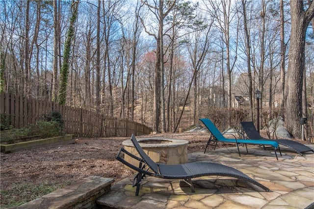 view of patio / terrace with fence and a fire pit
