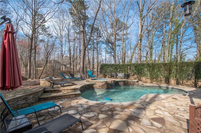 view of swimming pool with a fenced in pool, an in ground hot tub, a patio, and fence
