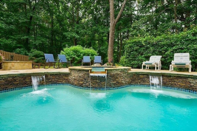pool with a patio area and fence