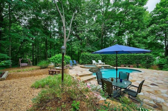 view of swimming pool featuring a patio and a pool with connected hot tub