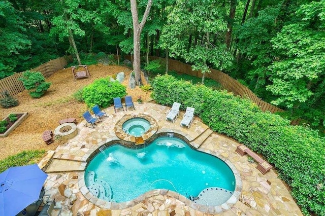 view of pool featuring a fenced in pool, an in ground hot tub, a fenced backyard, and a patio area
